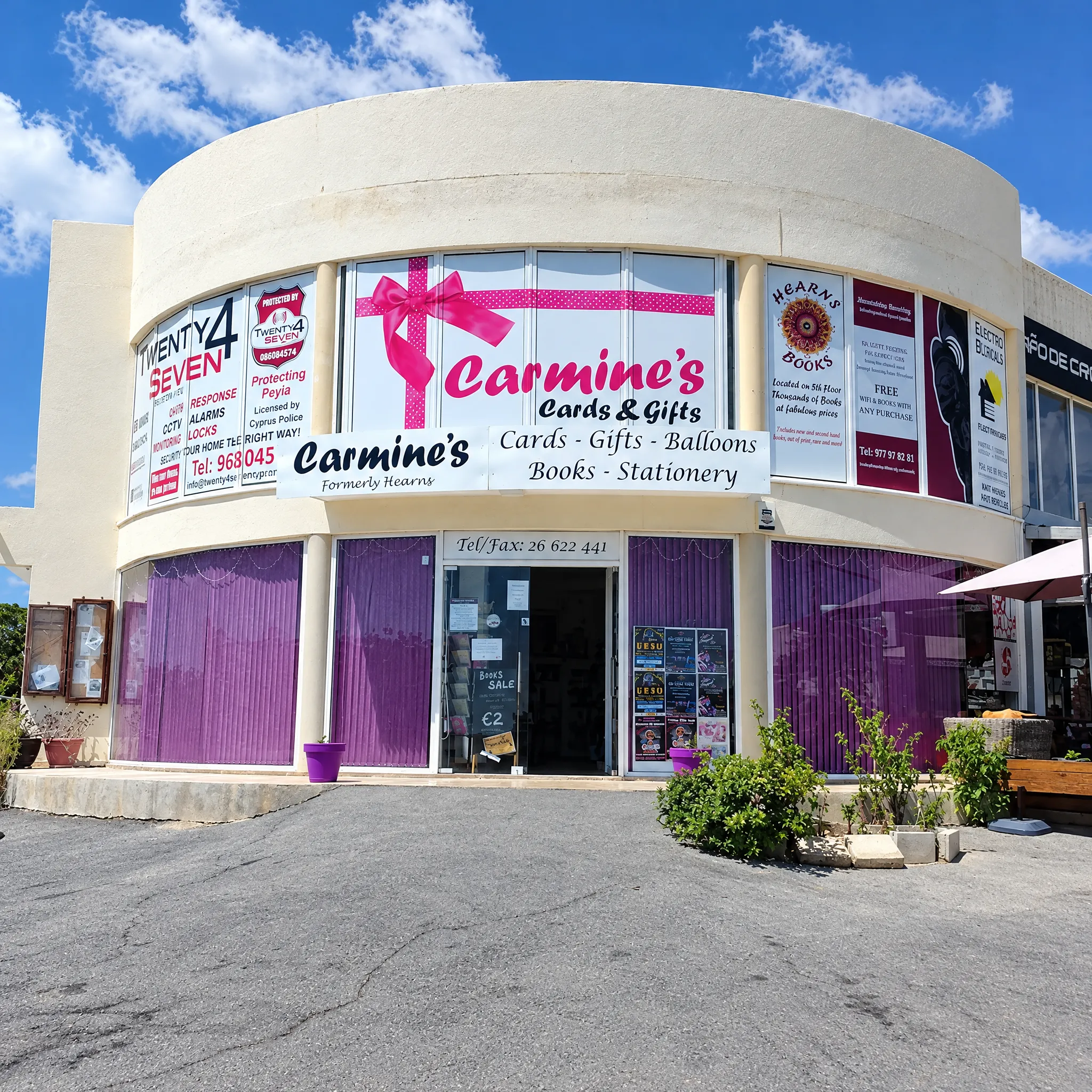 The Carmine's Cards and Gifts shop front with the pink ribbon in the window